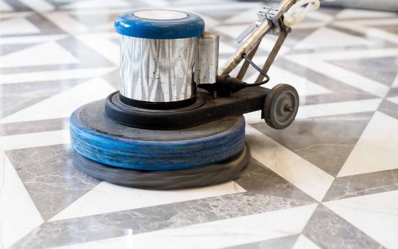 man polishing marble floor in modern office building