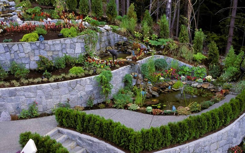 A stone retaining wall in a landscaped garden in Vancouver, British Columbia, Canada.